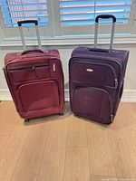 Front view of both Samsonite suitcases showing color, pockets, handles and wheels