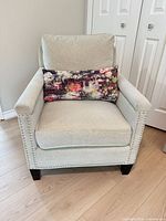 Front view of upholstered armchair with pillow in place