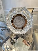 Front view of Waterford cut crystal octagonal mantel clock on glass table