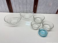 Overview of six glass bowls on table