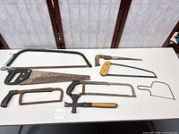 Overall view of seven hand tools laid out on table