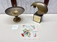 Compote bowl, trophy sculpture and souvenir handkerchief overview