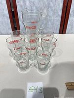 Full view of glass pitcher and eight glasses