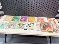 Tabletop view showing all sheet music pieces laid out in two rows