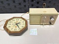Front view of GE clock radio and octagonal wall clock