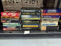 Full view of two stacks totaling 23 Isaac Asimov hardcovers on shelf