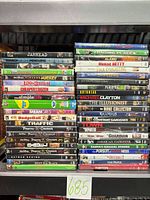 Two stacks of standard DVD cases showing front spines; visible mixed-genre titles and studios