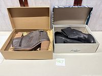 Overview of two pairs of Lucky Brand ankle boots in their boxes