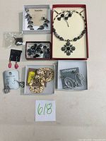 Group shot showing all nine jewellery pieces in boxes and on cards