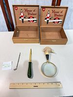 Overview of all items including two wooden cigar boxes, magnifier, letter opener, miniature golf club