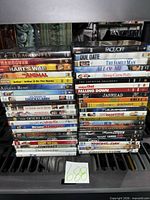 Two stacks of DVDs showing spines for title confirmation and condition