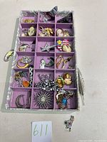 Tray containing approximately 30 assorted vintage costume brooches and pins in various compartments