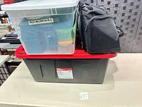 Entire lot showing tote, clear bin of containers, duffel