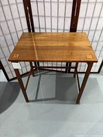 Full view of side table front left showing overall form and inlays