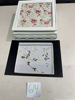 Jewelry box closed showing floral lid; open drawer displaying necklace, bracelet, earrings