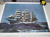 Overall view of lithograph showing sailing ship imagery, full sheet visible
