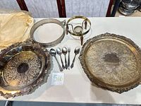 Top view showing both trays, utensils, brass stand, silver riser