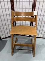 front view of Stokke Tripp Trapp chair showing seat, backrest and overall condition