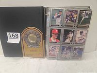 Closed binder with Leaf Set Baseball Edition graphic beside an open page showing nine card fronts