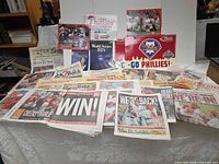 Overview of newspapers, signs and photo board spread on table