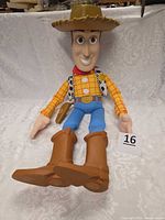 Full view of Woody figure seated showing overall size and features with lot number card