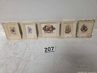 All five framed miniature prints lined up