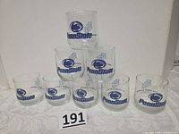 Front view of eight Penn State glasses stacked pyramid style