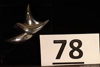 front view of polished sterling silver dove brooch-pendant with lot number