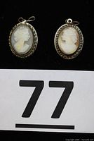 Front view of both cameo pendants showing carved profiles and twisted silver borders