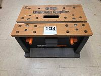 Top view of Workmate ShopBox showing work surface panels, dog holes and branding