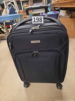 Full front view showing entire suitcase, wheels, handle
