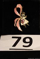 Front view of Bob Mackie angel awareness ribbon pin