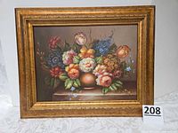Full view of framed floral oil painting with lot number