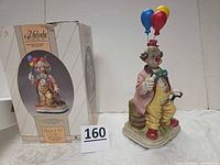 Front view of figurine next to original box