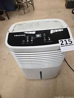 Front view of Hisense dehumidifier showing grille and size reference