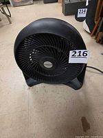 Front angled view of black Honeywell fan showing grille and logo