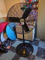 Full view of pedestal fan with cage, stand and base