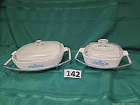 Both casserole sets with lids in chrome cradles