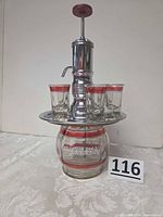 Full view of assembled dispenser set showing decanter, pump, tray, six glasses