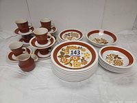 Full view of stacked dinnerware showing cups, saucers, plates, bowls, creamer