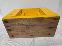 stamped side of yellow wooden pattern block