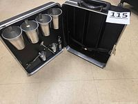 case opened showing cups, tools, and bottle section