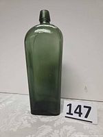 Full front view of green tapered bottle with lot number