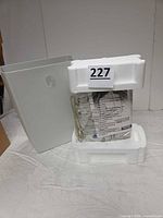 Shredder bin, styrofoam inserts, wrapped shredder head with manual visible