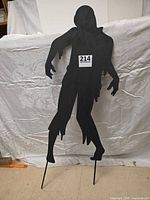 Front view of black Sasquatch silhouette showing overall design and stakes