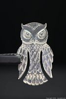 front view of owl-shaped sterling silver bookmark showing detail