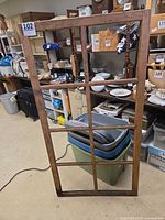 Full view of stripped wooden window frame standing upright