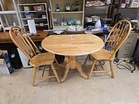 Table and two chairs fully assembled with leaves up