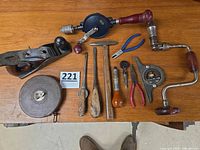 Group shot of all vintage tools on wooden surface