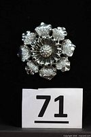 front view of brooch showing floral design and rhinestones